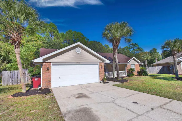 a view of a house with a yard and garage
