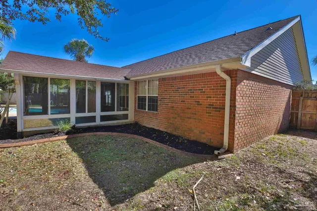 a backyard of a house with plants and trees