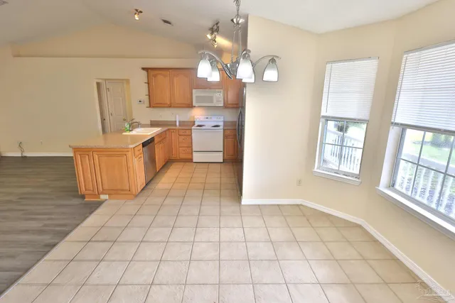 a large white kitchen with cabinets and a fireplace