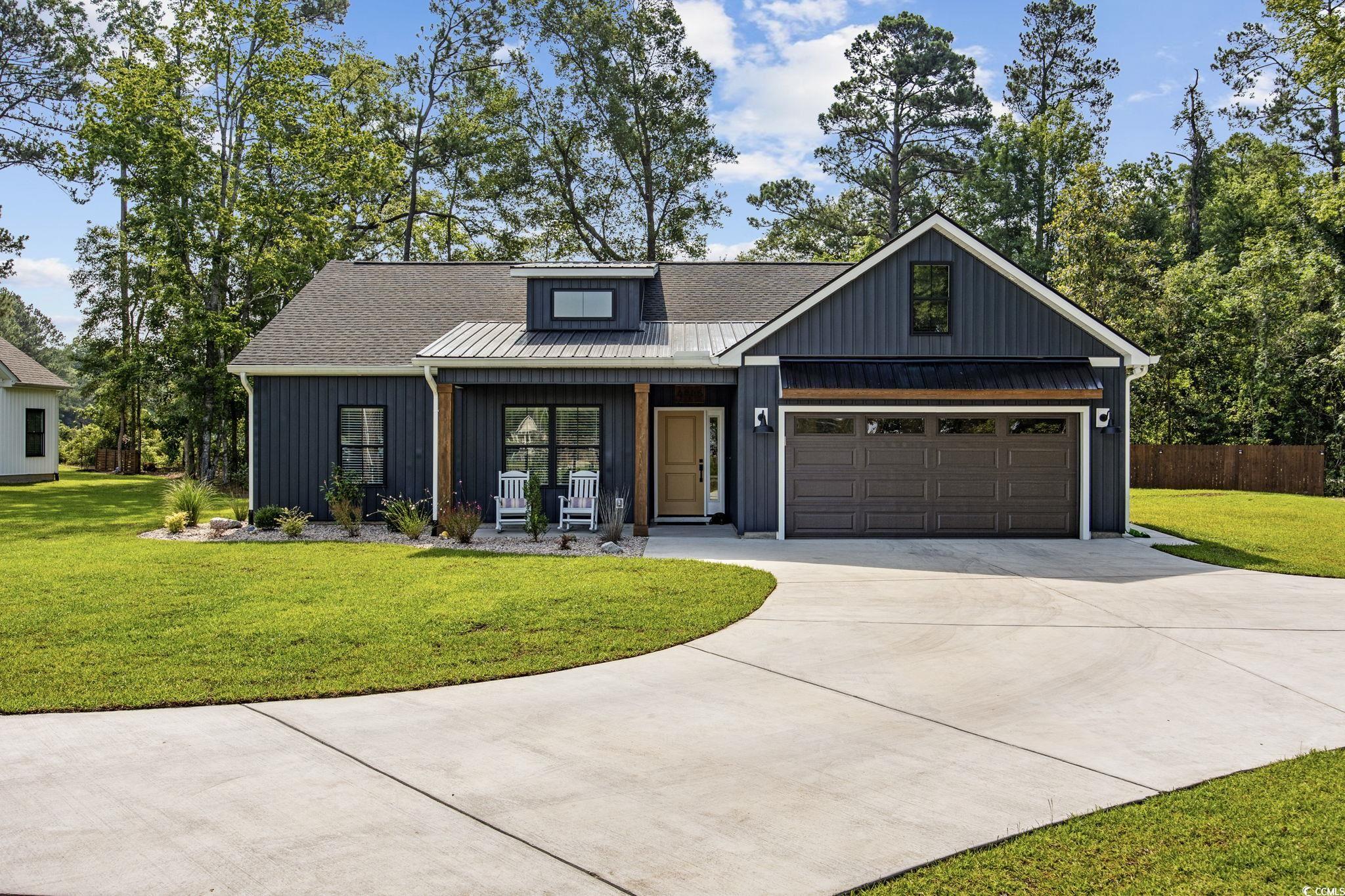 4446 Boggy Road Conway, SC 29526 - Photo 1 of 25 Modern farmhouse featuring a porch, driveway, a garage, and board and batten siding