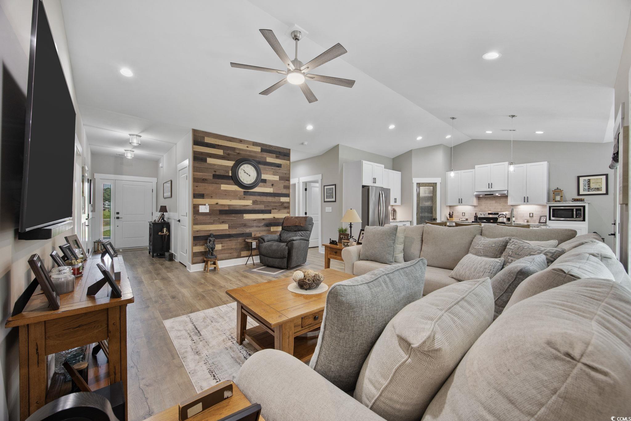 4446 Boggy Road Conway, SC 29526 - Photo 2 of 25 Living area with lofted ceiling, a ceiling fan, wooden walls, light wood-type flooring, and recessed lighting