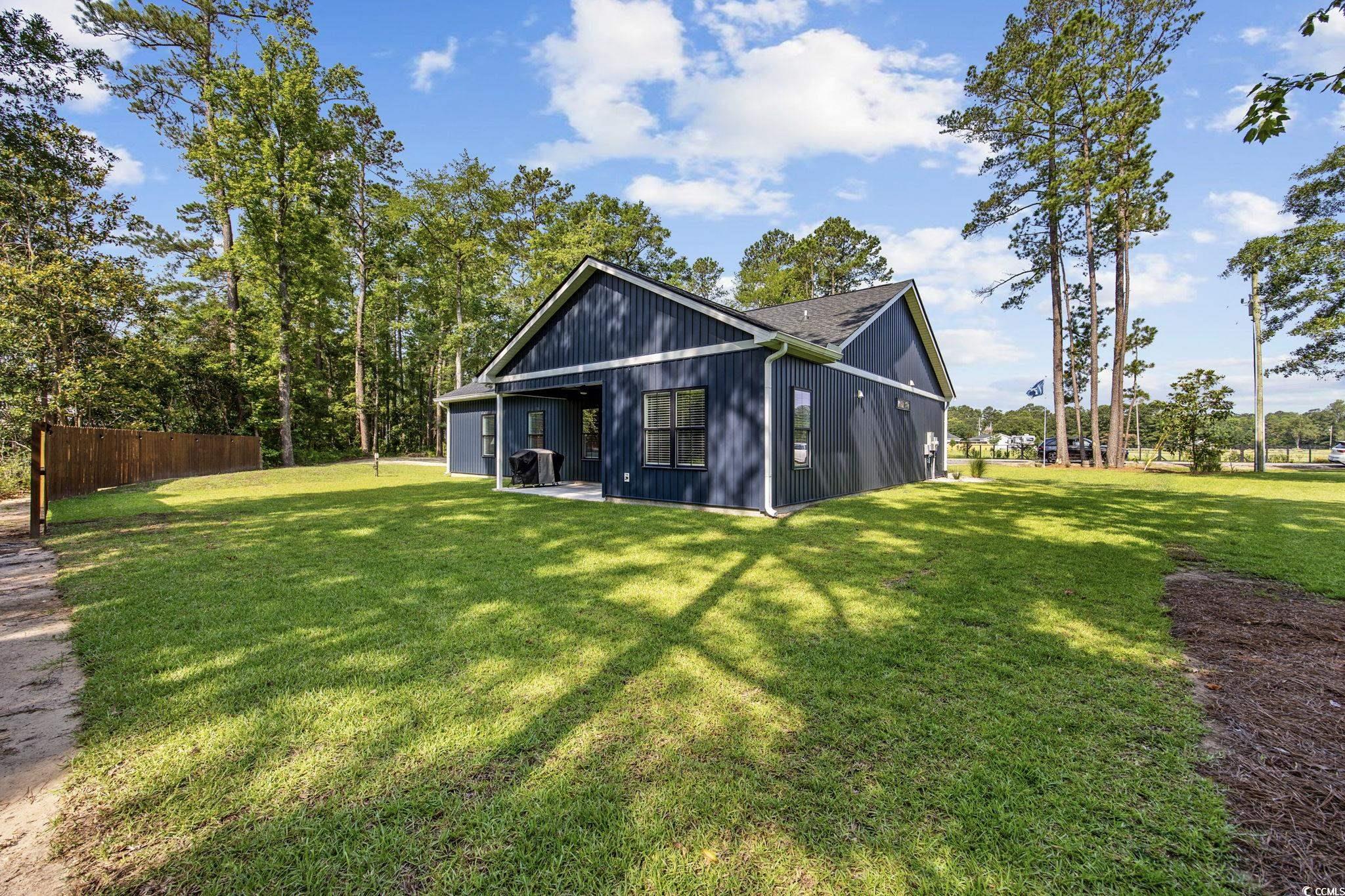 4446 Boggy Road Conway, SC 29526 - Photo 5 of 25 Back of property featuring a shingled roof and a patio area