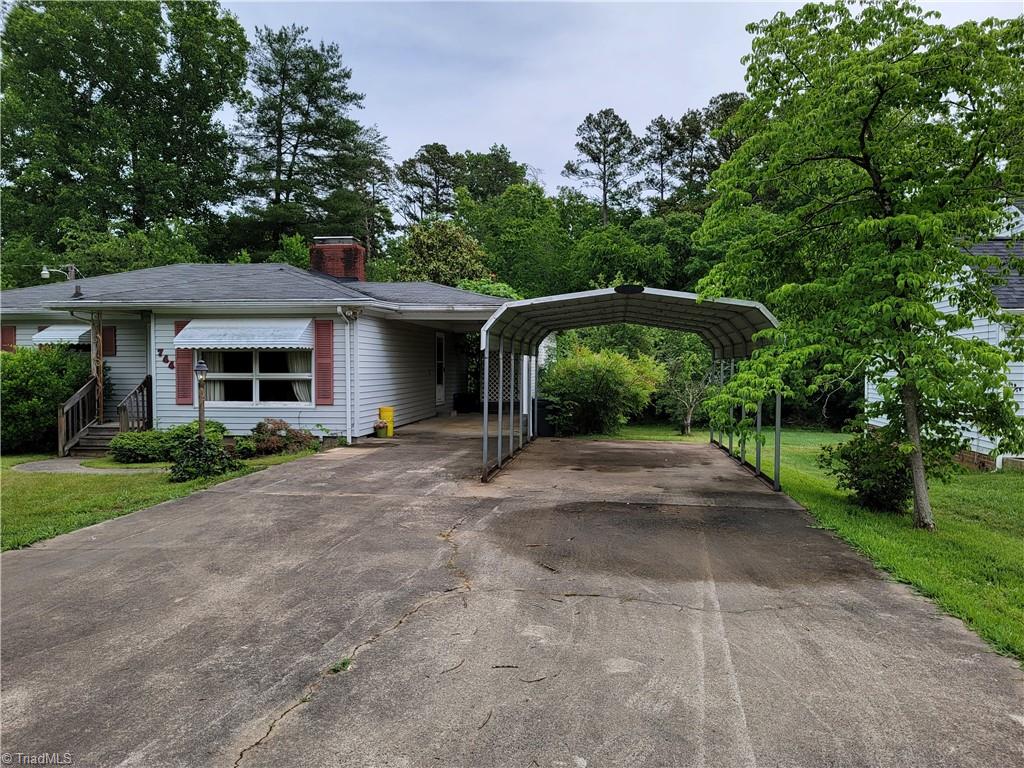 744 Stokesburg Road Walnut Cove, NC 27052 - Photo 2 of 41 Driveway is wide and has carport with house and additional carport to the right.