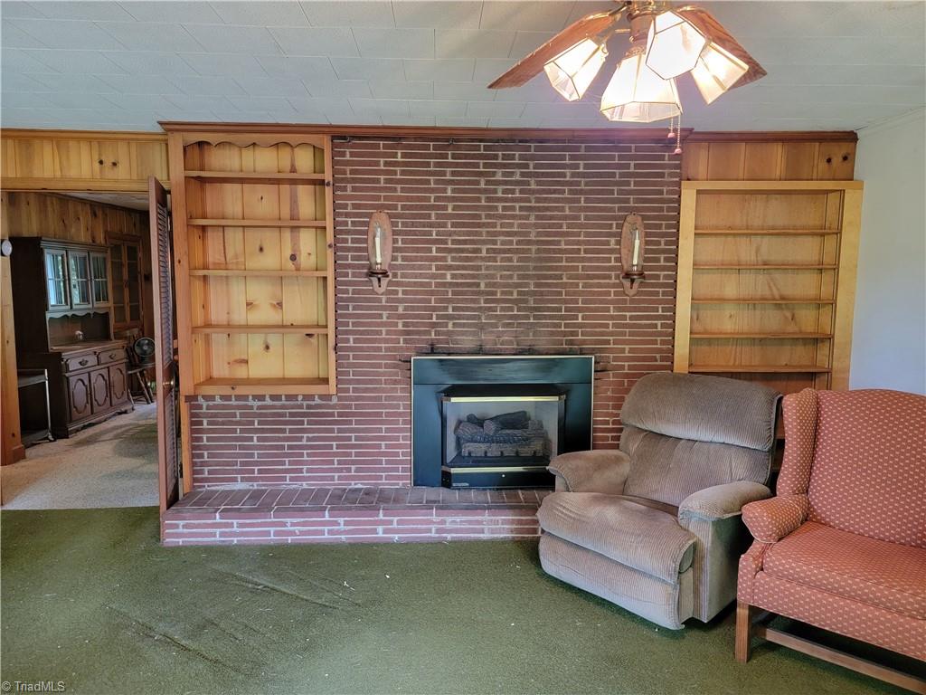 744 Stokesburg Road Walnut Cove, NC 27052 - Photo 9 of 41 Living Room with Fireplace and Brick surround