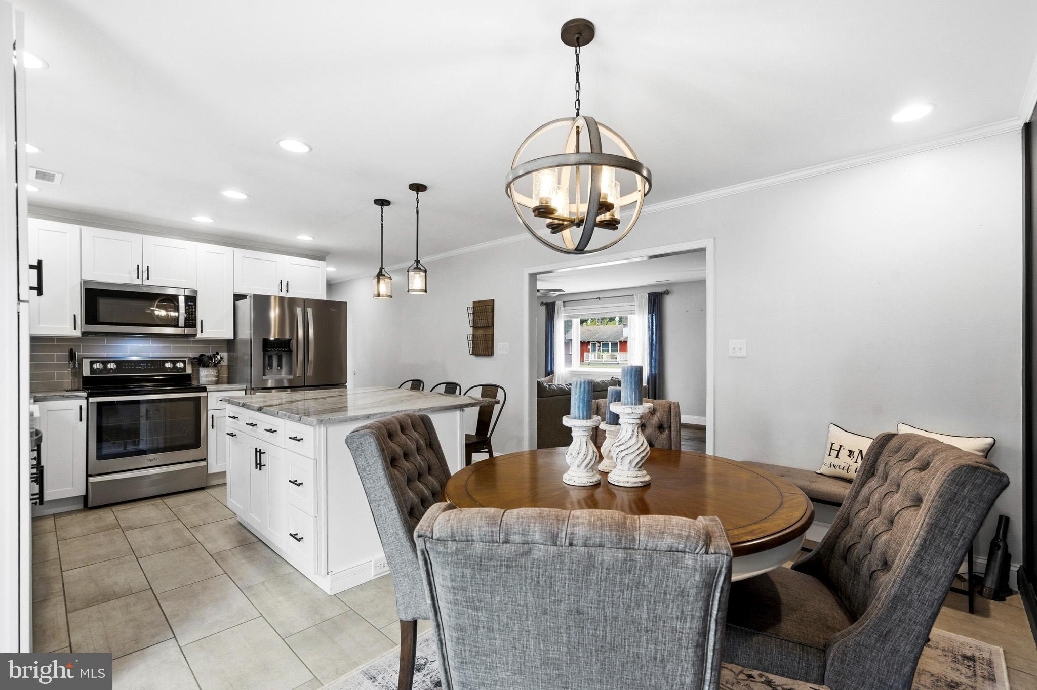 3930 Dogwood Road Port Republic, MD 20676 - Photo 11 of 48 a view of a dining room with furniture wooden floor and chandelier