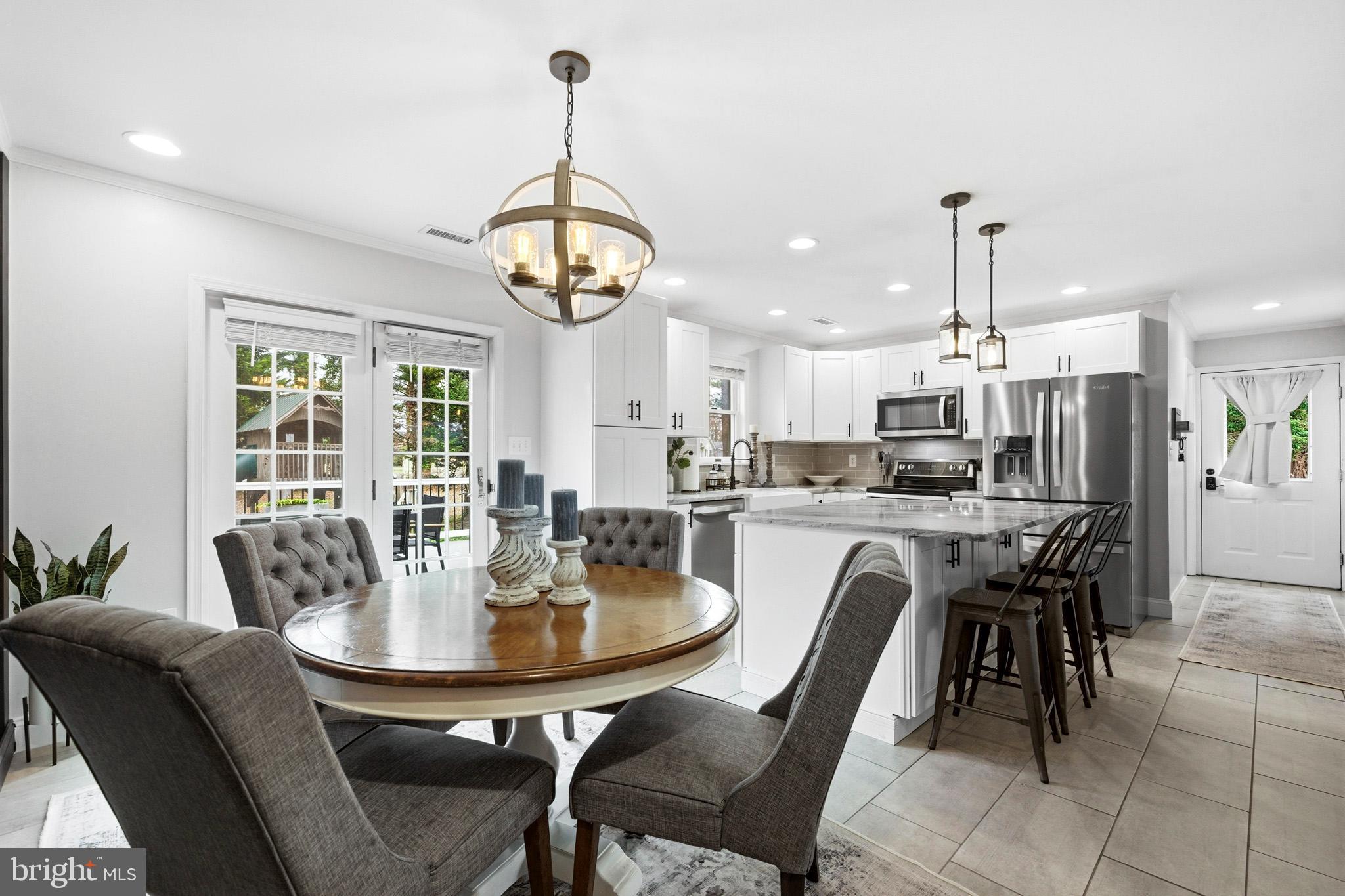 3930 Dogwood Road Port Republic, MD 20676 - Photo 12 of 48 a dining room with furniture a chandelier and wooden floor