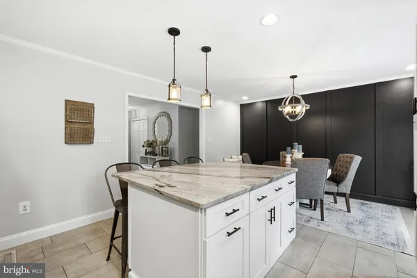 a kitchen with granite countertop a sink window and cabinets