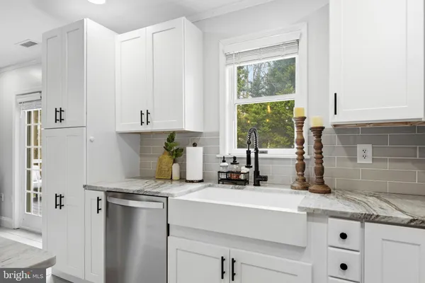 a kitchen with stainless steel appliances and a stove top oven