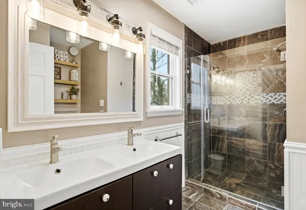 a bathroom with a glass shower door