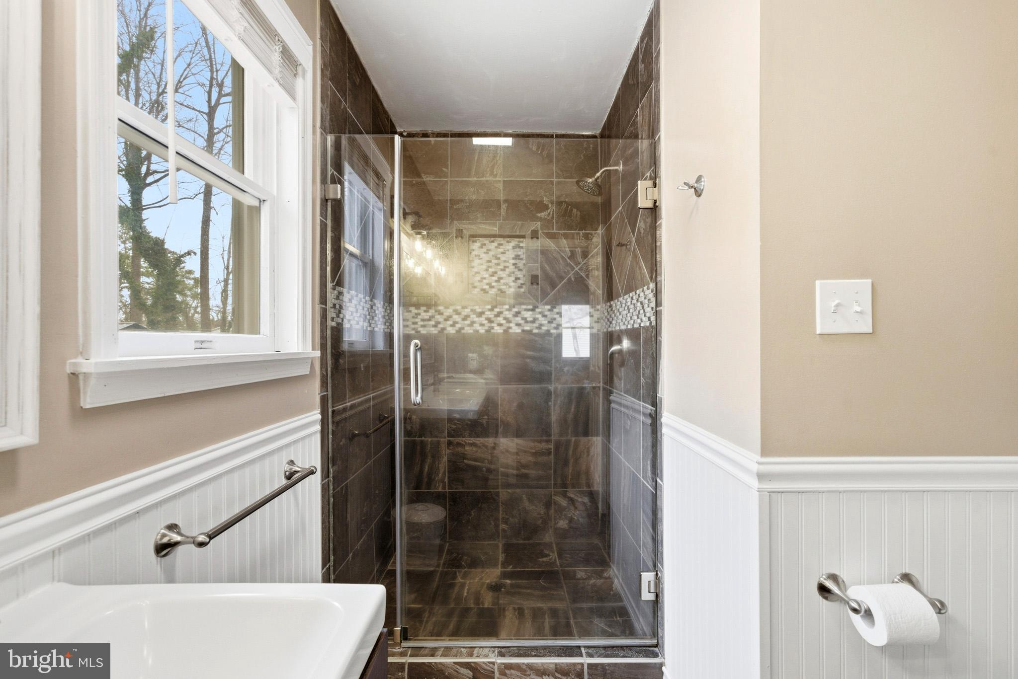 3930 Dogwood Road Port Republic, MD 20676 - Photo 24 of 48 a bathroom with a glass shower door