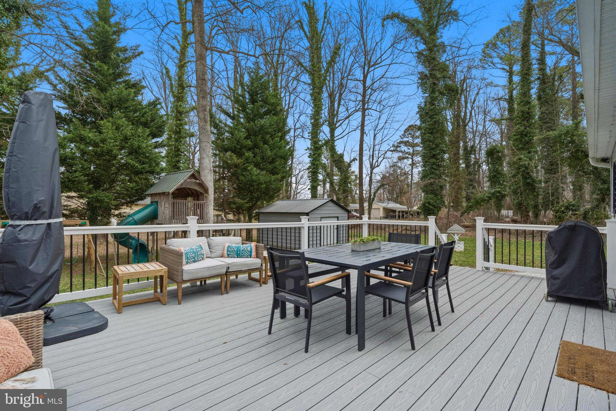 3930 Dogwood Road Port Republic, MD 20676 - Photo 31 of 48 a view of a roof deck with table and chairs couches with wooden floor and fence