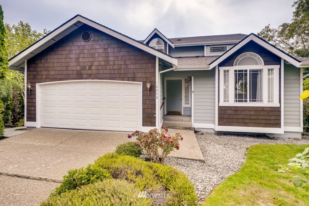 16648 Sylvester Road Southwest Burien, WA 98166 - Photo 1 of 36 a front view of a house with a garage