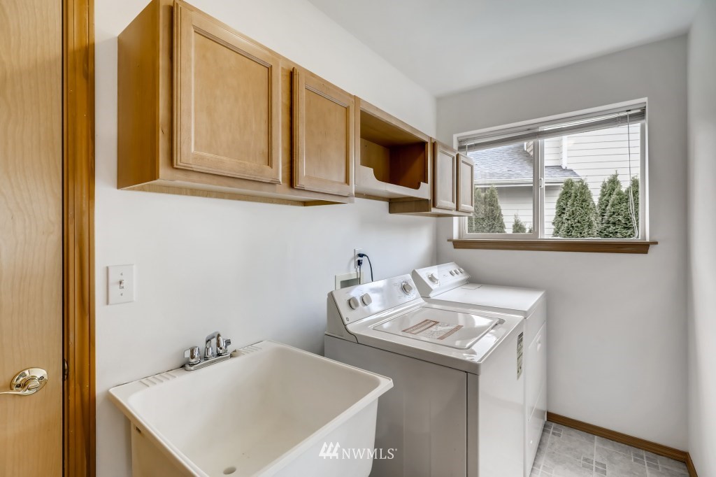 16648 Sylvester Road Southwest Burien, WA 98166 - Photo 14 of 36 a kitchen with stainless steel appliances granite countertop a sink and a microwave