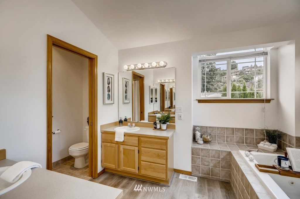 16648 Sylvester Road Southwest Burien, WA 98166 - Photo 18 of 36 a room with a bed and a view of bathroom