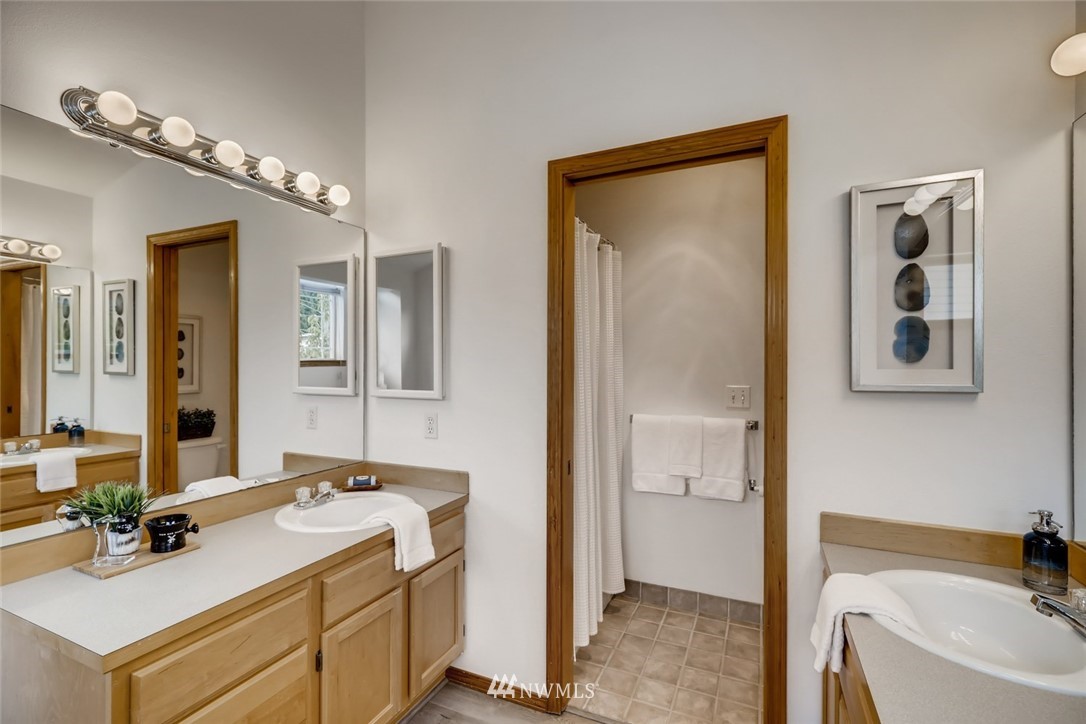 16648 Sylvester Road Southwest Burien, WA 98166 - Photo 19 of 36 a bathroom with a sink vanity tub and shower