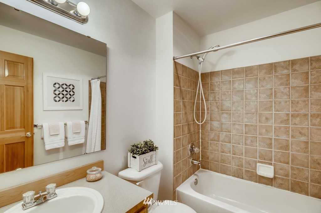 16648 Sylvester Road Southwest Burien, WA 98166 - Photo 24 of 36 a bathroom with a sink a toilet and shower