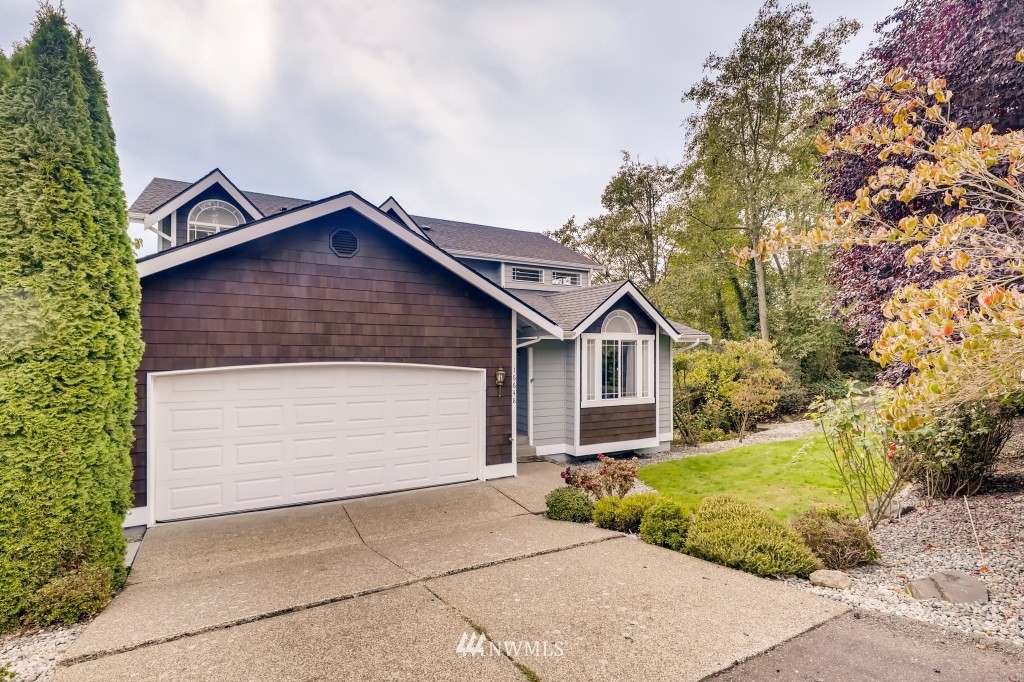 16648 Sylvester Road Southwest Burien, WA 98166 - Photo 36 of 36 a front view of a house with a yard and garage