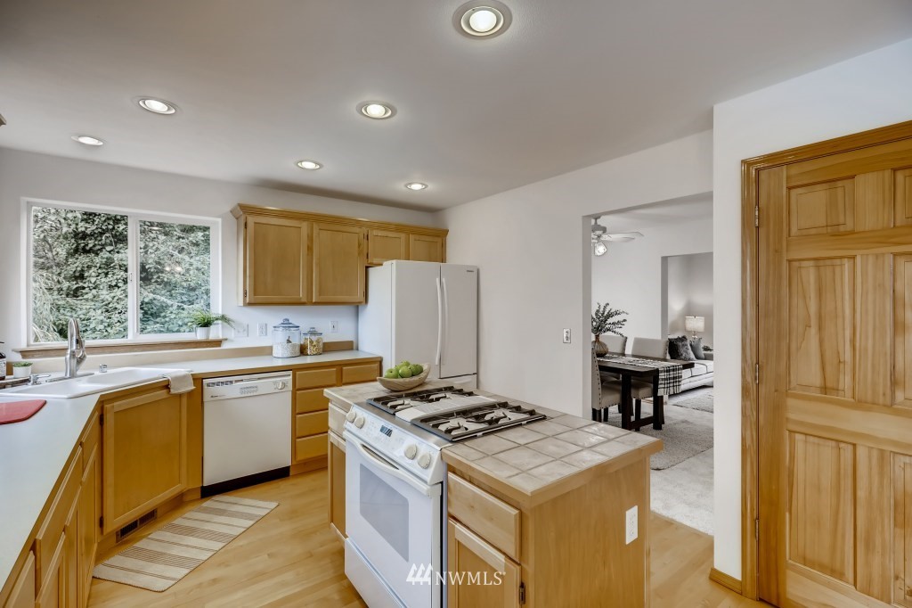 16648 Sylvester Road Southwest Burien, WA 98166 - Photo 6 of 36 a kitchen with a stove a sink and a refrigerator