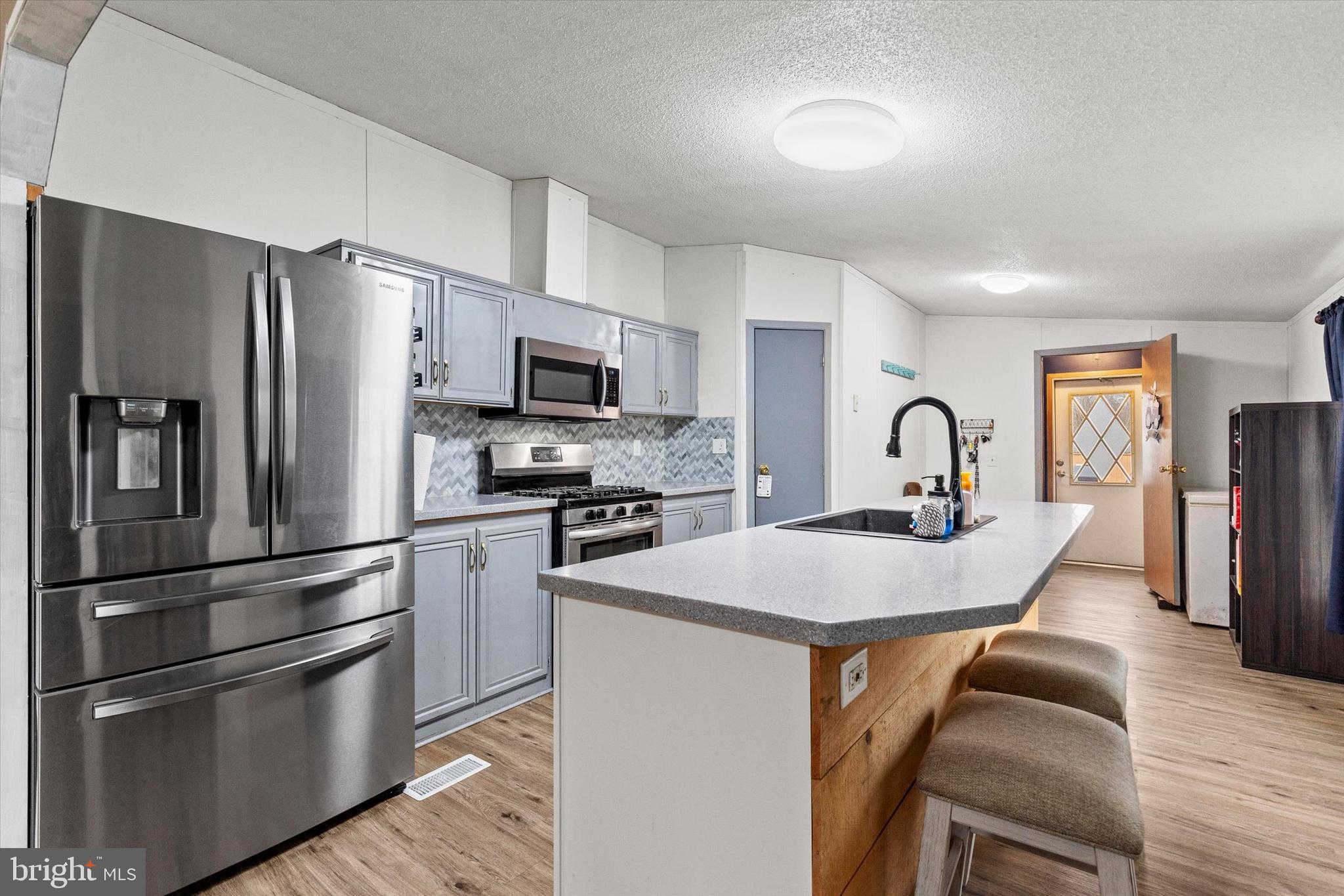 14 Junction Road Millersburg, PA 17061 - Photo 9 of 23 a kitchen with stainless steel appliances granite countertop a refrigerator a stove a sink and a refrigerator