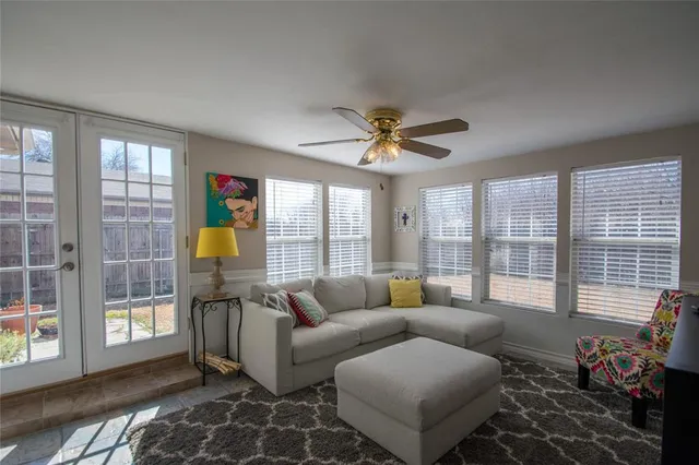 a living room with furniture and a floor to ceiling window