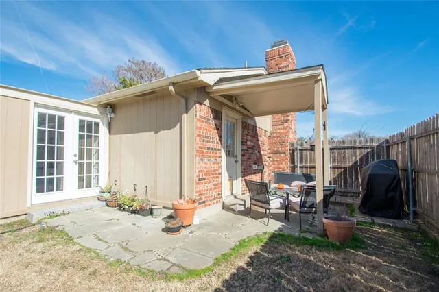 a view of a patio with table and chairs and potted plants