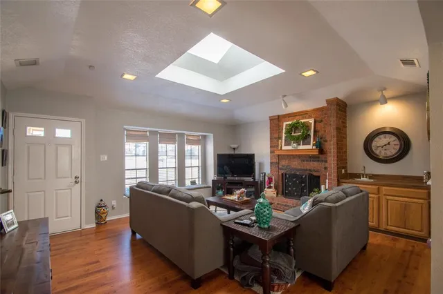 a living room with furniture a fireplace and a flat screen tv