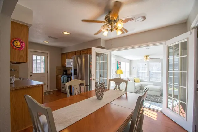 a view of a dining room with furniture wooden floor and chandelier