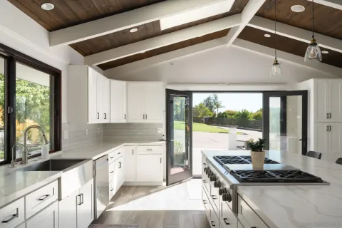 a kitchen with stainless steel appliances granite countertop a sink stove and cabinets