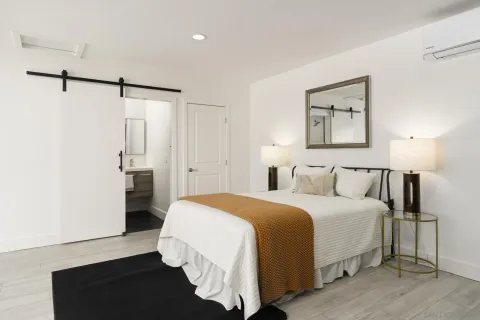 a bedroom with a bed and a night stand