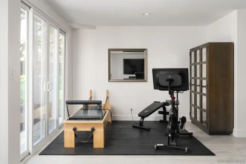 a living room with furniture and a dining table with potted plant