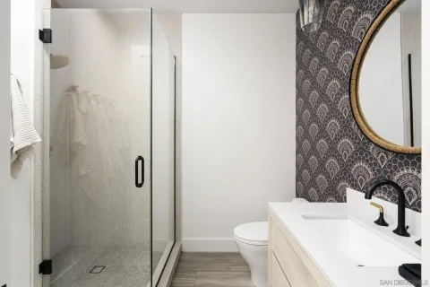 a bedroom with a large bed and a potted plant