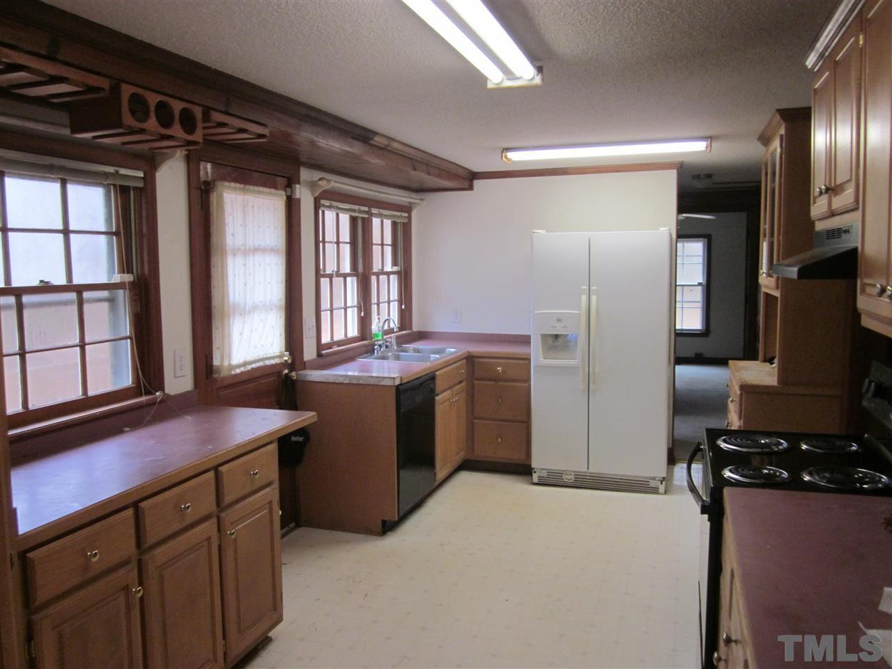 4720 Green Riley Road Rougemont, NC 27572 - Photo 3 of 8 a kitchen with a refrigerator and a stove