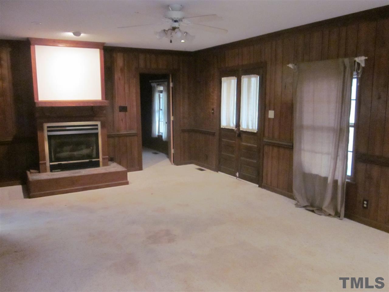 4720 Green Riley Road Rougemont, NC 27572 - Photo 5 of 8 a bedroom with a bed and a fireplace