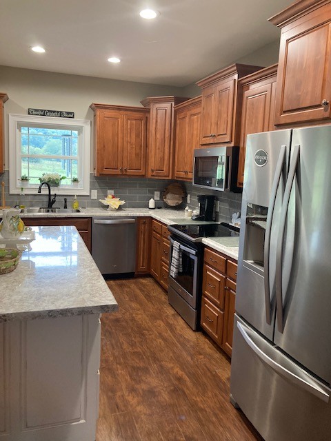 370 Red Hill Road Normandy, TN 37360 - Photo 8 of 38 a kitchen with stainless steel appliances granite countertop a refrigerator a sink a stove a microwave and wooden cabinets