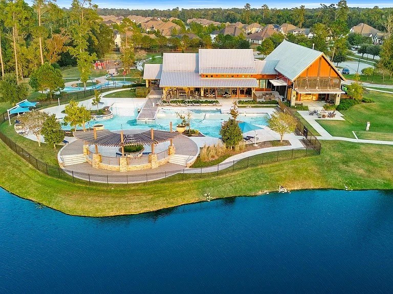 8551 Tombron Grove Road Magnolia, TX 77354 - Photo 47 of 49 7.5 acres of fun featuring 9400 sq ft clubhouse and resort amenities and dog park. Home away from home! Resort-style swimming pool, the perfect oasis for the whole family. Fitness center and 200 acres of open space. Hike and bike trails and entertaining areas with outdoor and indoor gathering areas. Perfect for quiet evenings with family or a fun night out with friends and neighbors.