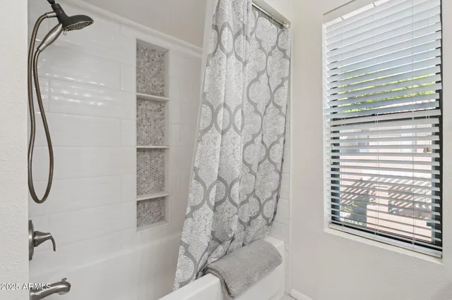 a bathroom with a shower and a bathtub