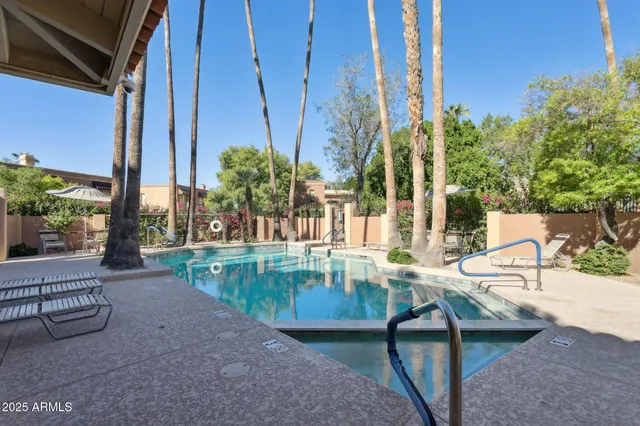 a view of a swimming pool with a lounge chair