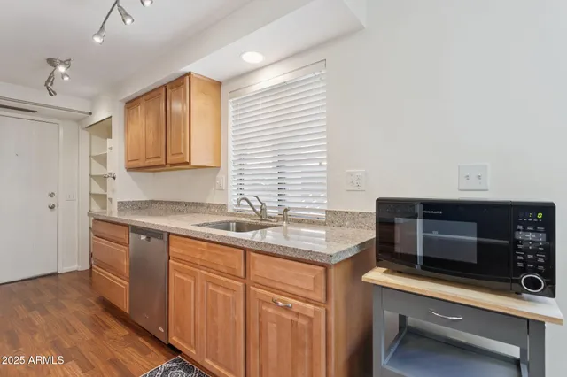 a kitchen with stainless steel appliances a stove sink and microwave