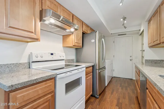 a kitchen with a stove a sink and a refrigerator