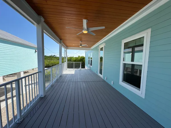 a view of a porch with wooden floor