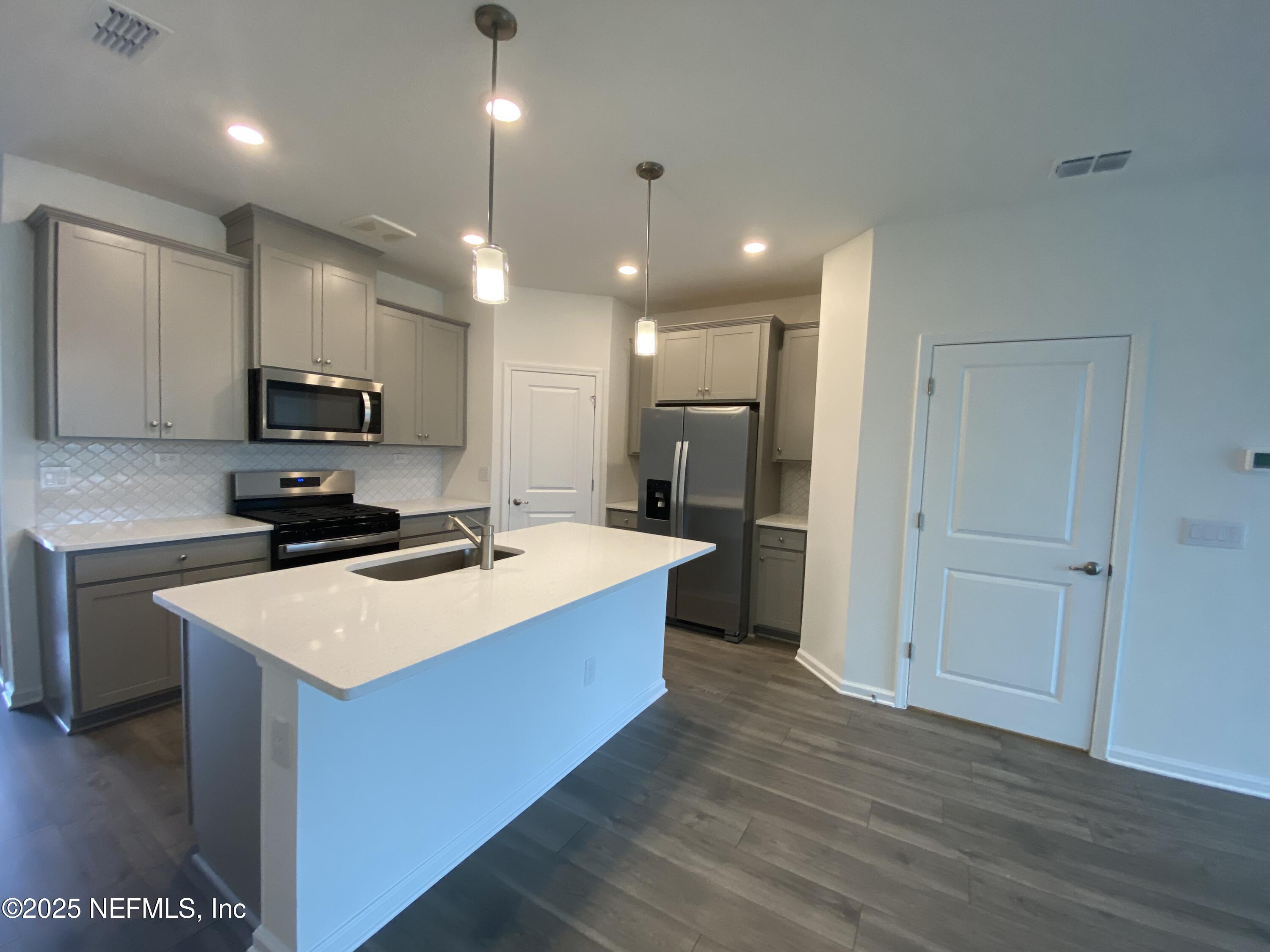 269 Brandon Lks Drive St. Augustine, FL 32092 - Photo 3 of 16 a kitchen with stainless steel appliances granite countertop a sink stove and refrigerator