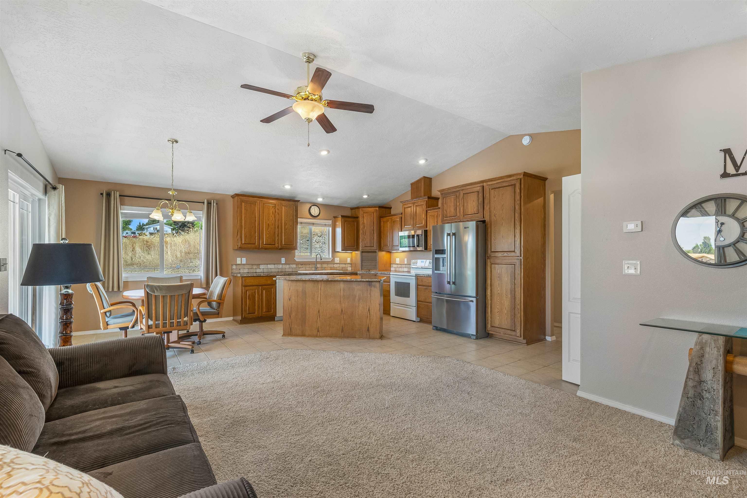 935 Grelle Avenue Lewiston, ID 83501 - Photo 13 of 33 Living area with vaulted ceiling, ceiling fan, light carpet, light tile patterned flooring, and recessed lighting