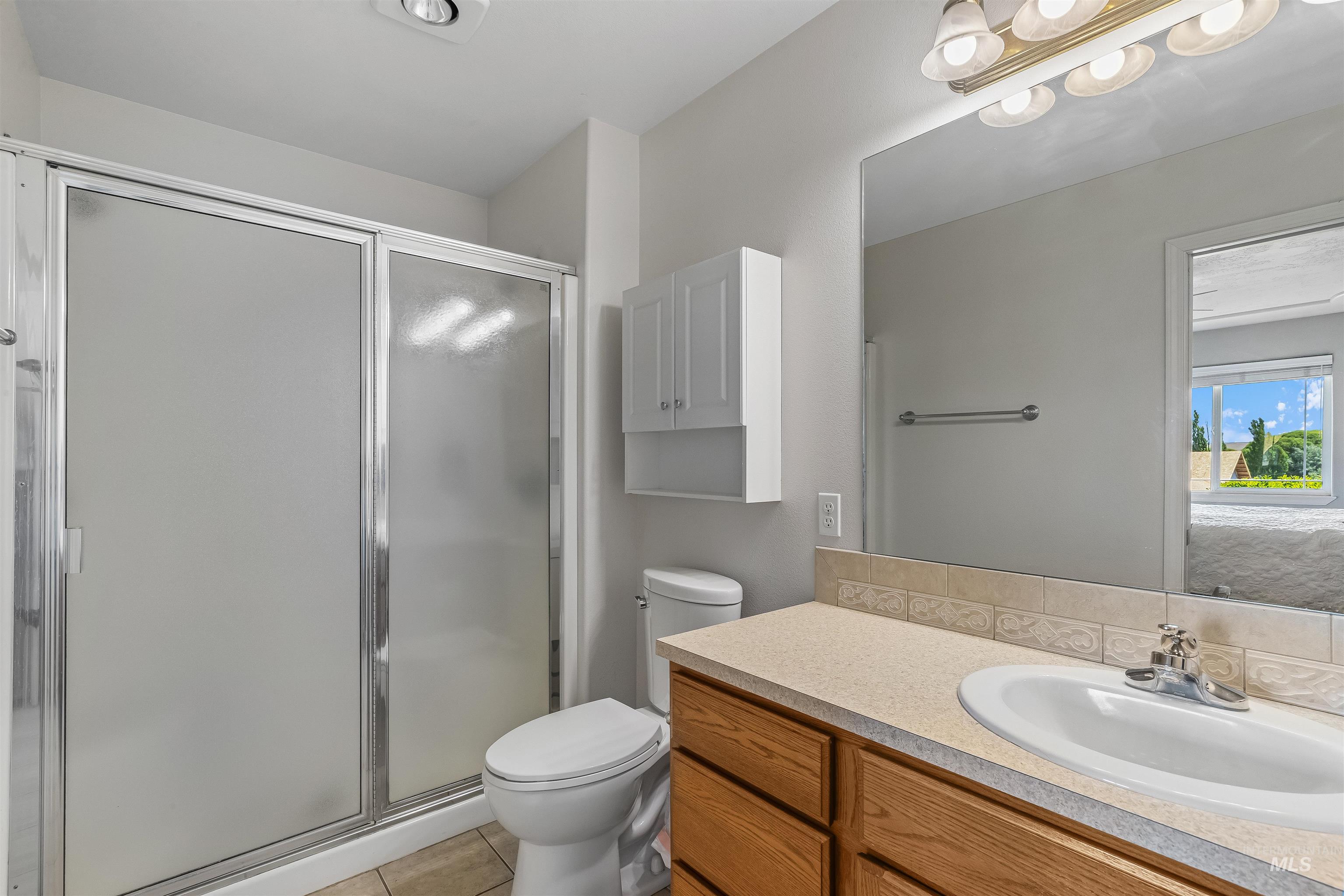935 Grelle Avenue Lewiston, ID 83501 - Photo 24 of 33 Bathroom featuring vanity, a stall shower, and tile patterned flooring