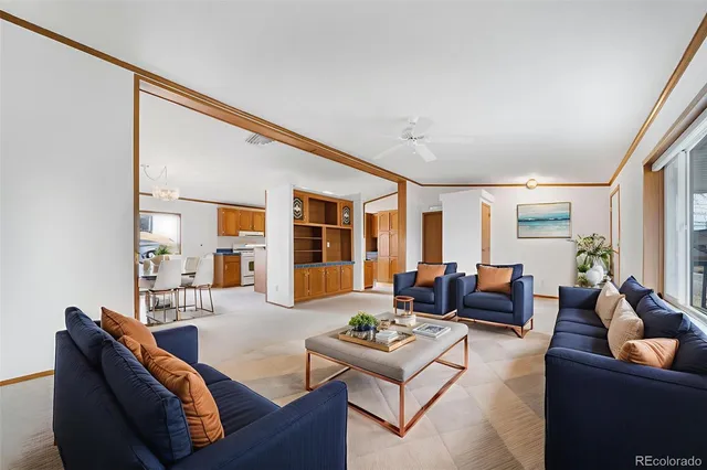 a living room with furniture and floor to ceiling window
