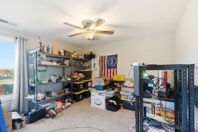 a view of a workspace with furniture and a window