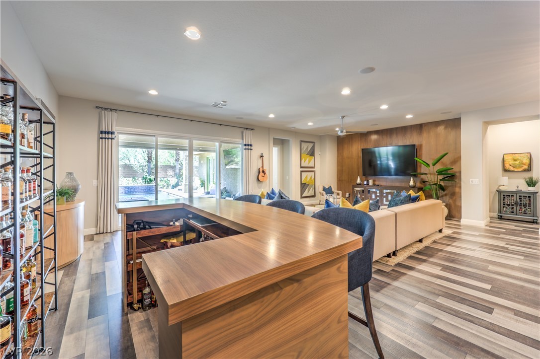 7119 Arabian Ridge Street Las Vegas, NV 89131 - Photo 24 of 73 An open-concept living space with a wet bar and seamless indoor-outdoor living.