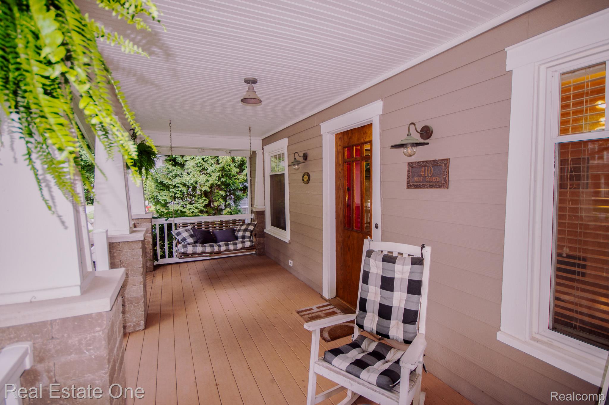 410 West 4th Street Rochester, MI 48307 - Photo 4 of 33 Inviting covered front porch with a wood-finish floor and white beadboard ceiling