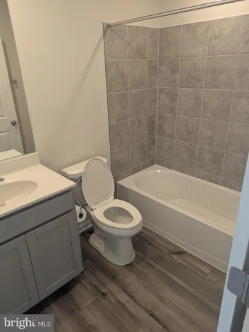 a bathroom with a toilet and a bathtub