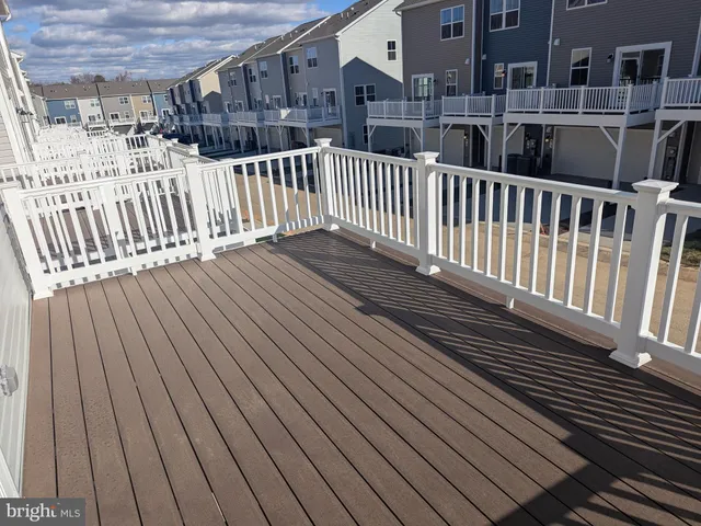 a view of deck with wooden floor and fence