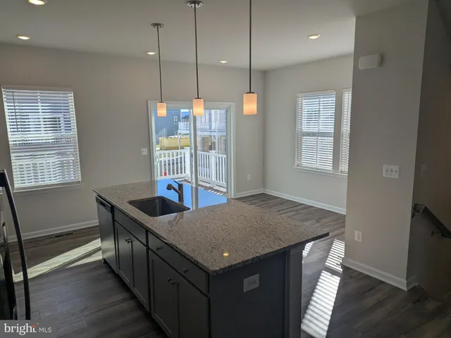 a kitchen that has a kitchen island hardwood floor and a window